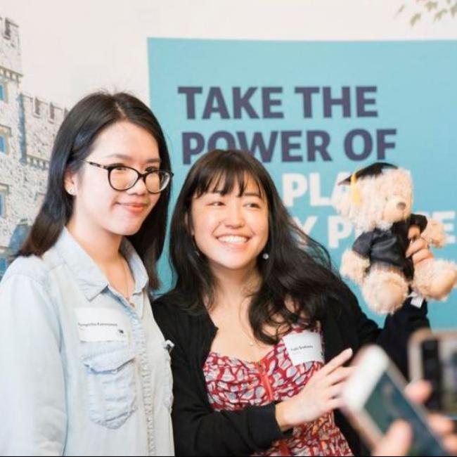 Two alumni at an alumni event smiling