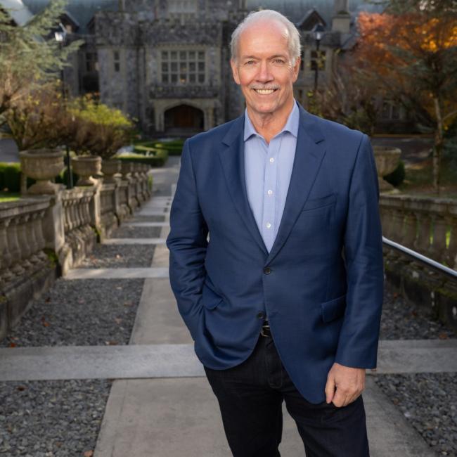 John Horgan standing outside Hatley Castle at Royal Roads University.