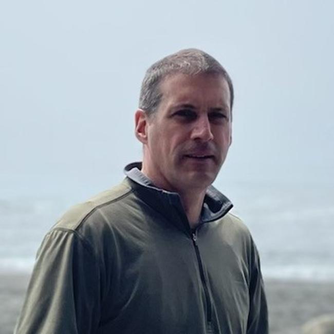 Man standing by the beach.