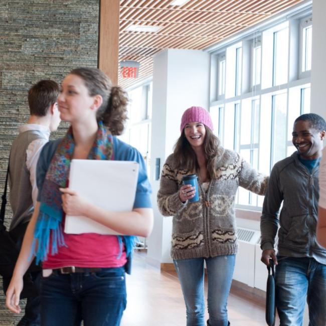 A busy hallway with students rushing past at Royal Roads University