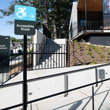 Accessible route signage and entry ramp at the Dogwood Auditorium.